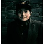 A boy wears a hat with an emblem of national flag120X96cm edition 10  2005